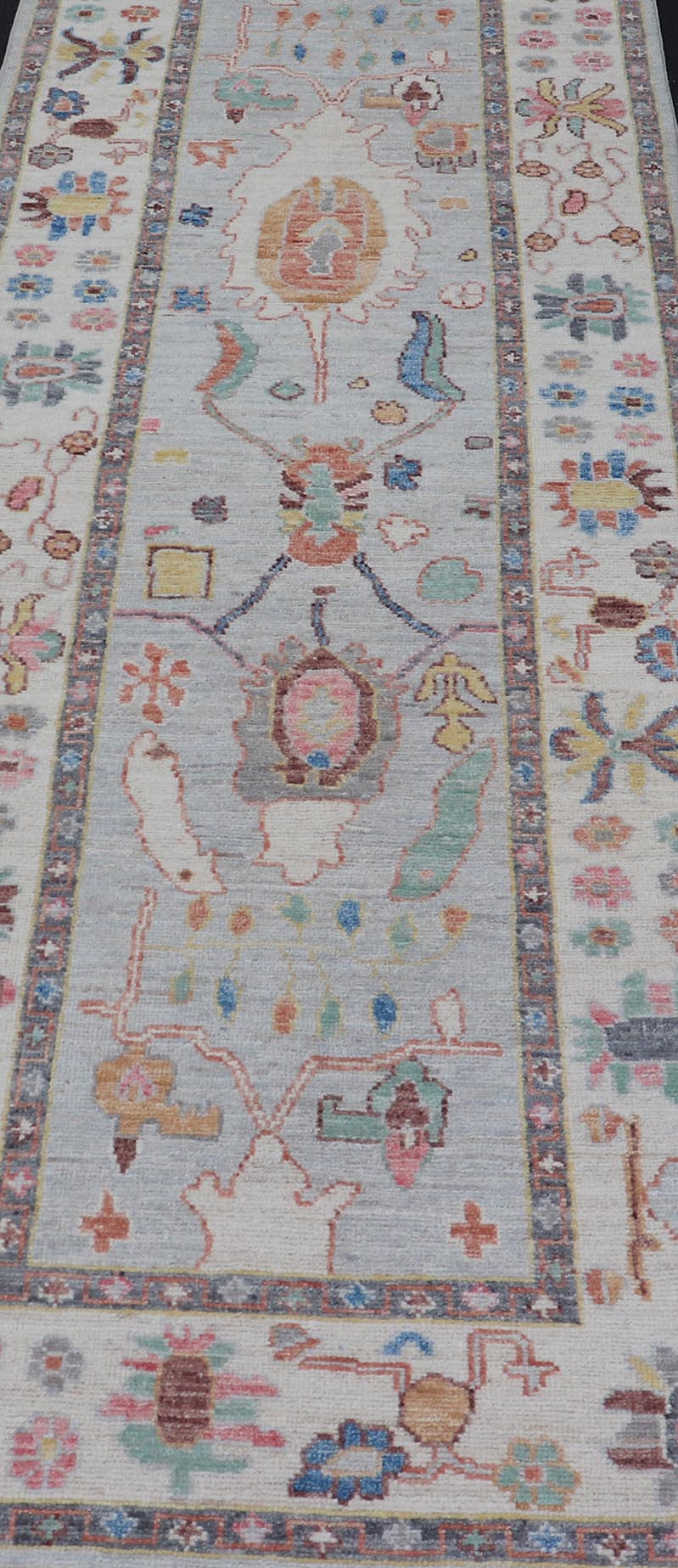 Measures: 3'1 x 10'0 Hand knotted in Afghanistan, this modern oushak runner showcasing the distinct large - scale angular floral design, with a modern bright splash of color against a cool gray background. The monotone cream - to - gray in the backgro... - Keivan Woven ArtsAWR - 6541 - 20085Rug