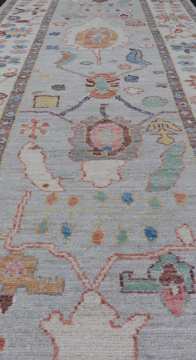 Measures: 3'1 x 10'0 Hand knotted in Afghanistan, this modern oushak runner showcasing the distinct large - scale angular floral design, with a modern bright splash of color against a cool gray background. The monotone cream - to - gray in the backgro... - Keivan Woven ArtsAWR - 6541 - 20085Rug