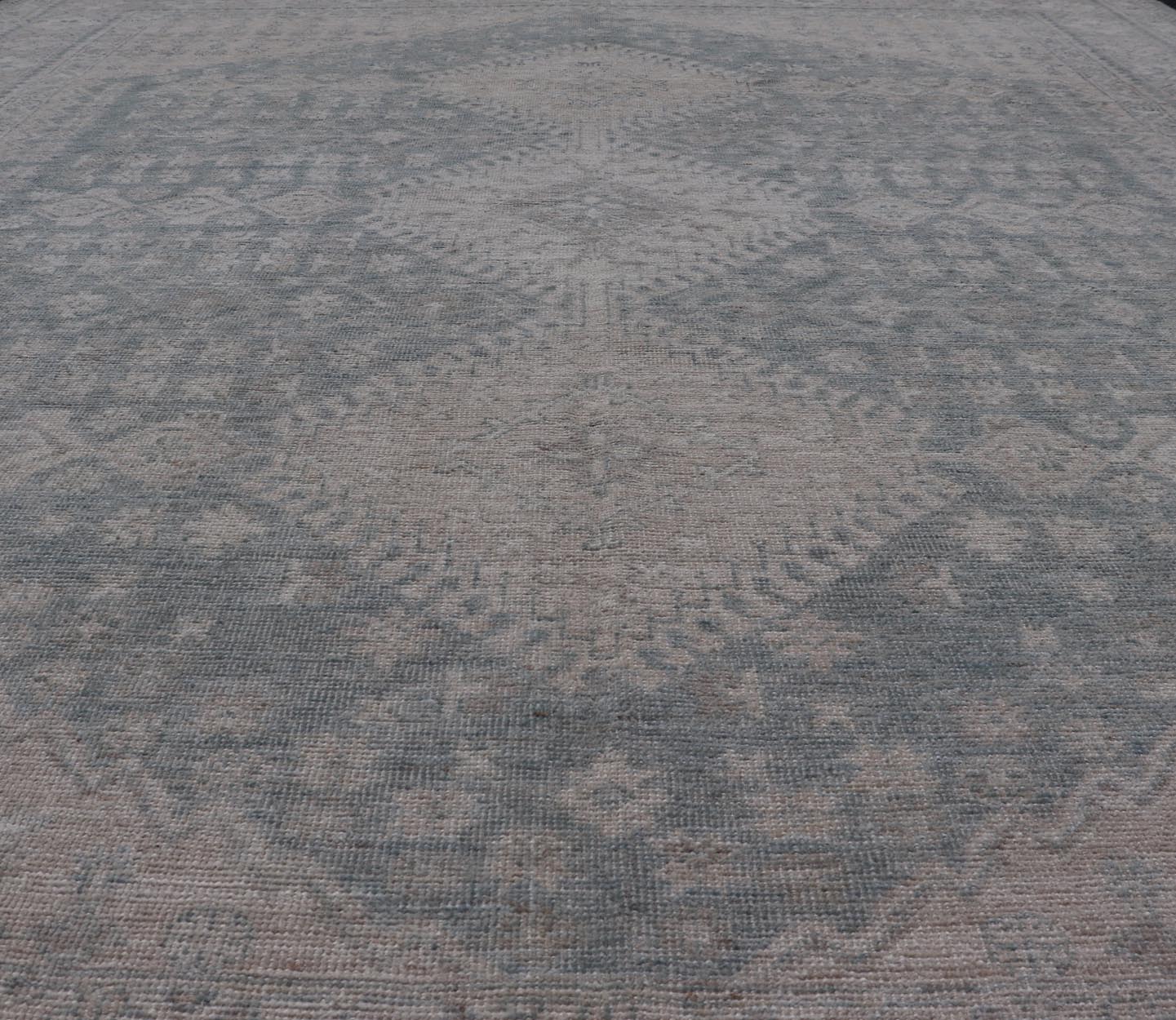 Modern Persian Shiraz Rug with Tribal Design in Light Blue Background and Taupe. Keivan Woven Arts/ rug AWR - 8003 Country of Origin: Afghanistan Type: Shiraz Design: Floral, Medallion Abstract - Tribal Measures: 8' x 9'9 This Shiraz present... - Keivan Woven ArtsAWR - 8003 - 21487Rug