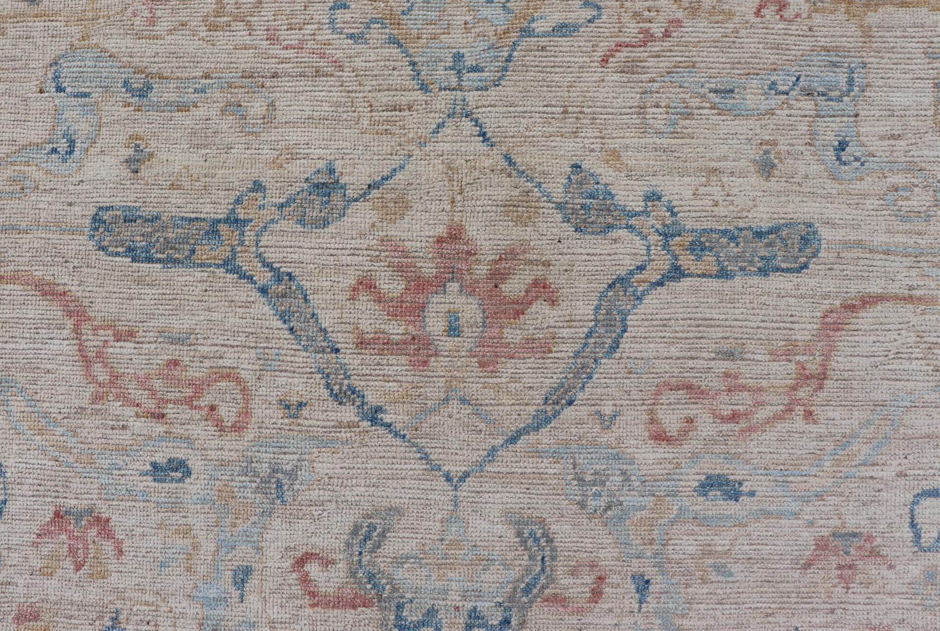 All - Over Hand Knotted Oushak Rug with Arabesque Design in Ivory and Blue Tones Hand knotted Oushak made in wool with a field is backed by a ivory color, with a light blue border, etched with elegant golden/brown branches. The arabesque - like des... - Keivan Woven ArtsAWR - 8252 - 21403Rug