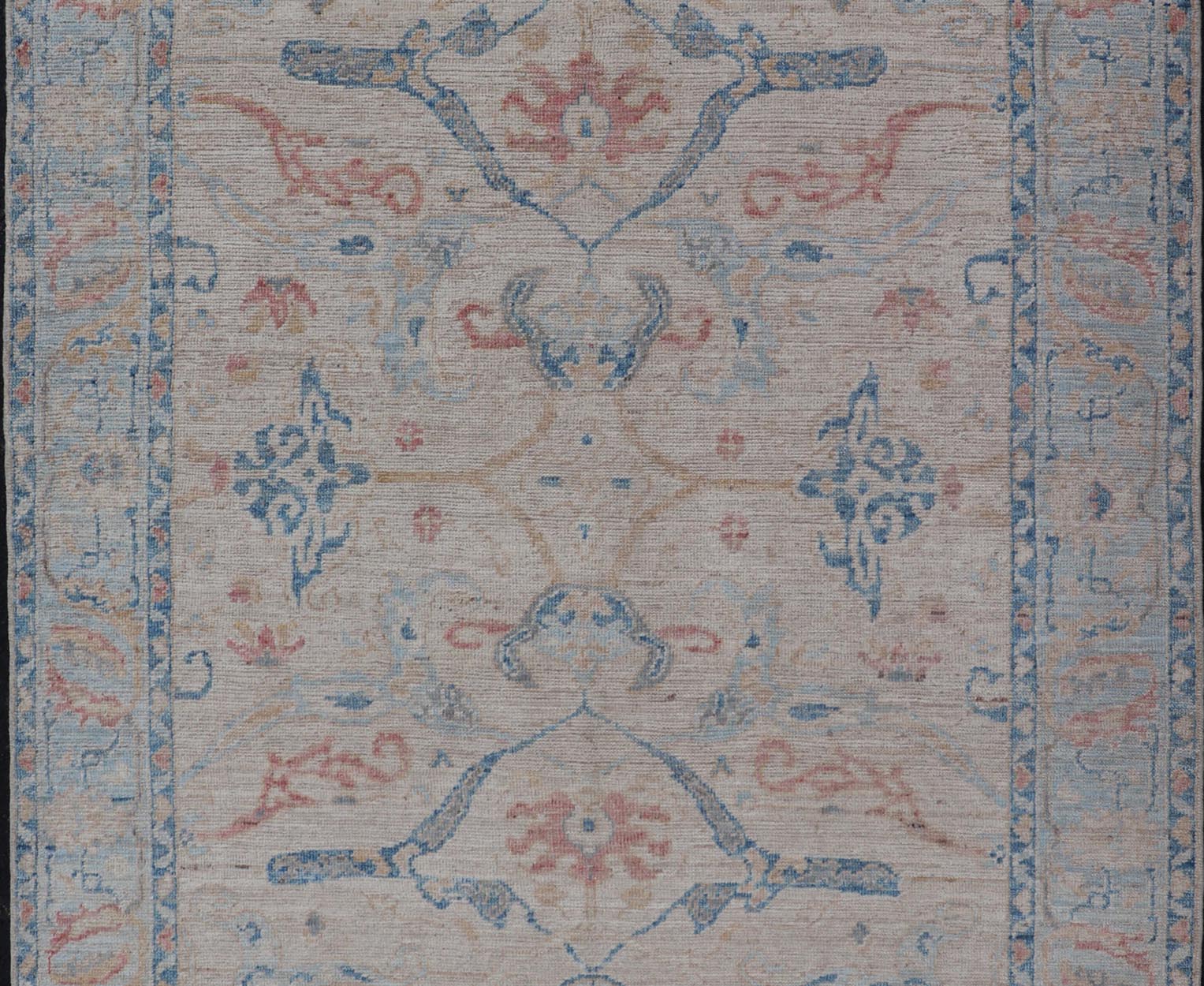 All - Over Hand Knotted Oushak Rug with Arabesque Design in Ivory and Blue Tones Hand knotted Oushak made in wool with a field is backed by a ivory color, with a light blue border, etched with elegant golden/brown branches. The arabesque - like des... - Keivan Woven ArtsAWR - 8252 - 21403Rug
