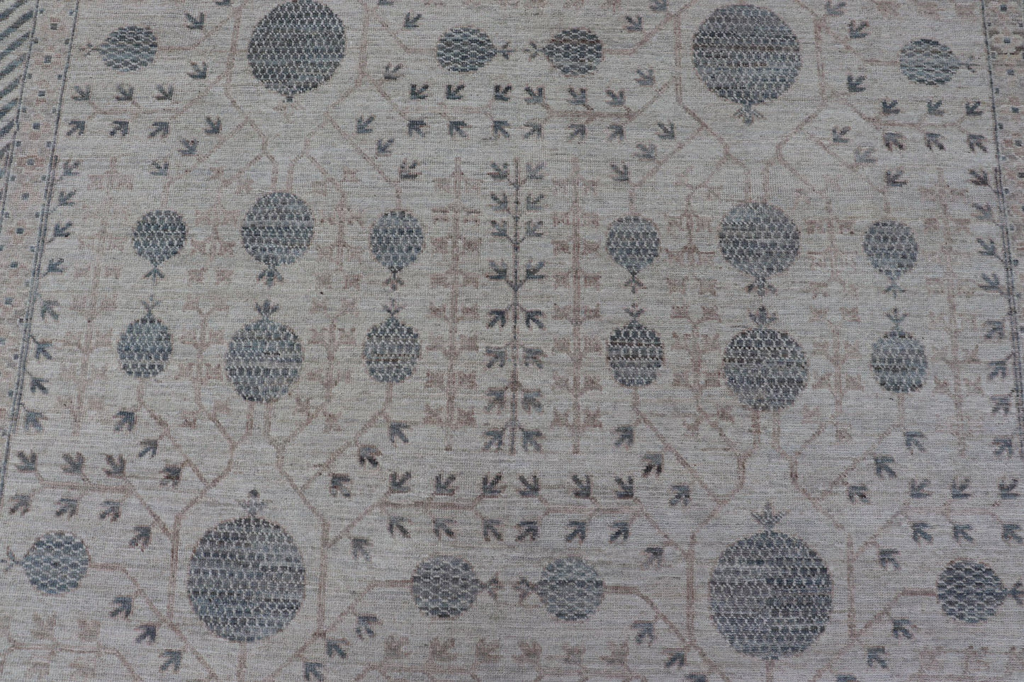 Modern Tribal Khotan Rug In Shades of Cream, Tan, and Light Teal This modern Khotan features a modern muted array of teal, cream, taupe. The background is a beautifully blended cream, topped by an intricate pomegranate design in teal . ... - Keivan Woven ArtsAWR - 8384 - 20836Rug