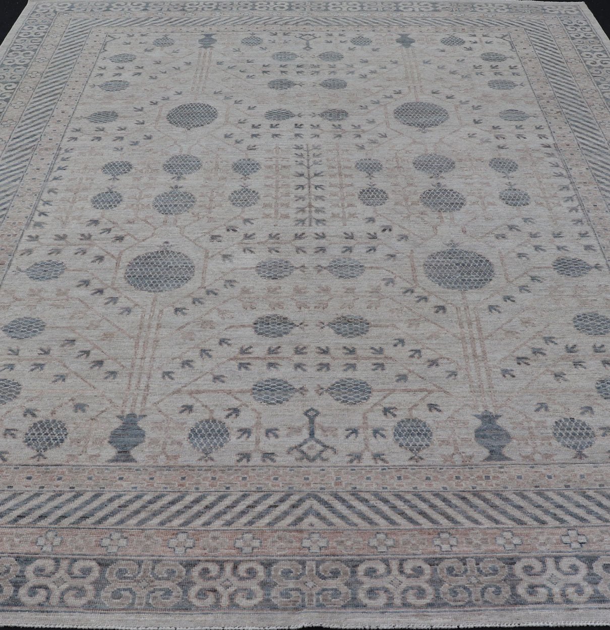 Modern Tribal Khotan Rug In Shades of Cream, Tan, and Light Teal This modern Khotan features a modern muted array of teal, cream, taupe. The background is a beautifully blended cream, topped by an intricate pomegranate design in teal . ... - Keivan Woven ArtsAWR - 8384 - 20836Rug
