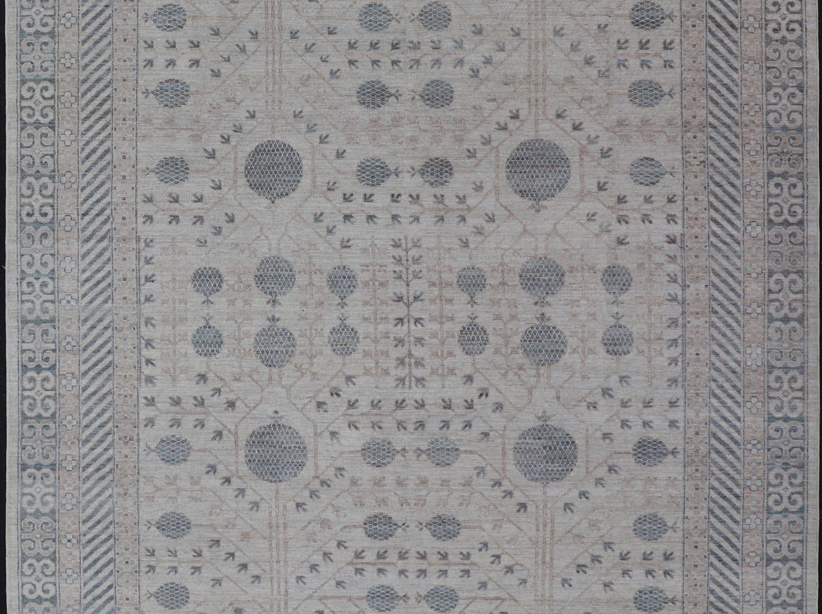 Modern Tribal Khotan Rug In Shades of Cream, Tan, and Light Teal This modern Khotan features a modern muted array of teal, cream, taupe. The background is a beautifully blended cream, topped by an intricate pomegranate design in teal . ... - Keivan Woven ArtsAWR - 8384 - 20836Rug