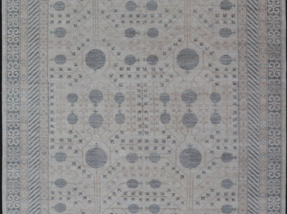 Modern Tribal Khotan Rug In Shades of Cream, Tan, and Light Teal This modern Khotan features a modern muted array of teal, cream, taupe. The background is a beautifully blended cream, topped by an intricate pomegranate design in teal . ... - Keivan Woven ArtsAWR - 8384 - 20836Rug