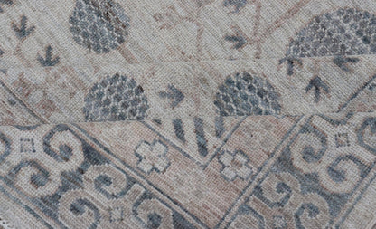 Modern Tribal Khotan Rug In Shades of Cream, Tan, and Light Teal This modern Khotan features a modern muted array of teal, cream, taupe. The background is a beautifully blended cream, topped by an intricate pomegranate design in teal . ... - Keivan Woven ArtsAWR - 8384 - 20836Rug
