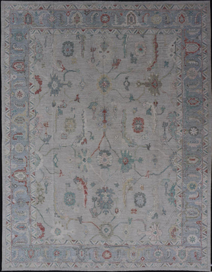 Large Modern Oushak with floral design on light blue/gray border with pops of color. Keivan Woven Arts; rug AWR - 9004 Country of Origin: Afghanistan Type: Oushak Design: Mosaic Floral, All - Over. 21st century. Measures: 10'1 x 13'10. The fi... - Keivan Woven ArtsAWR - 9004 - 21311Rug