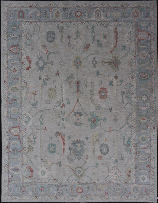 Large Modern Oushak with floral design on light blue/gray border with pops of color. Keivan Woven Arts; rug AWR - 9004 Country of Origin: Afghanistan Type: Oushak Design: Mosaic Floral, All - Over. 21st century. Measures: 10'1 x 13'10. The fi... - Keivan Woven ArtsAWR - 9004 - 21311Rug