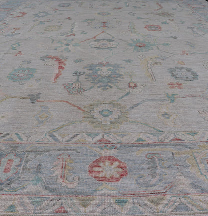 Large Modern Oushak with floral design on light blue/gray border with pops of color. Keivan Woven Arts; rug AWR - 9004 Country of Origin: Afghanistan Type: Oushak Design: Mosaic Floral, All - Over. 21st century. Measures: 10'1 x 13'10. The fi... - Keivan Woven ArtsAWR - 9004 - 21311Rug