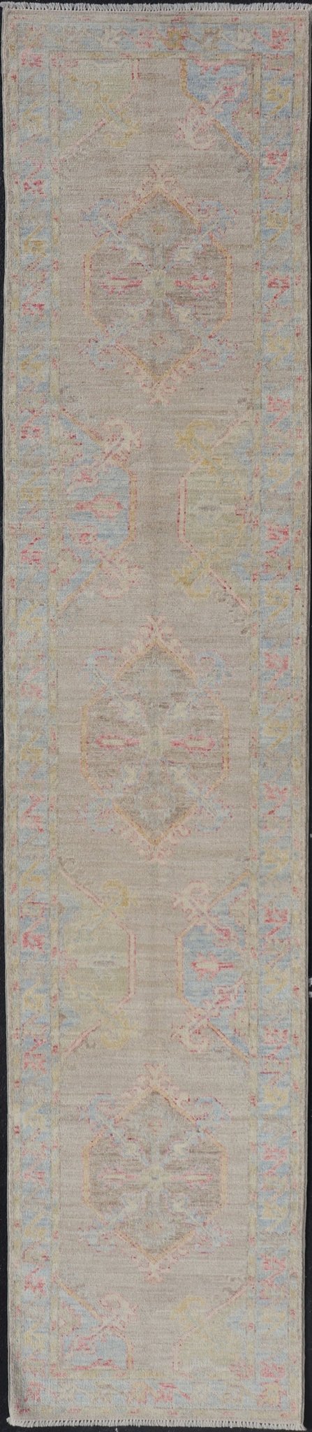 Hand - Knotted Oushak Runner With Medallion Design on a Tan Field With Red & Blue. Keivan Woven Arts; rug AWR - AR118 Country of Origin: Afghanistan Type: Oushak Design: Medallion, Motif, Floral Motif This modern piece holds large medallions in the ... - Keivan Woven ArtsAWR - AR118 - 17178