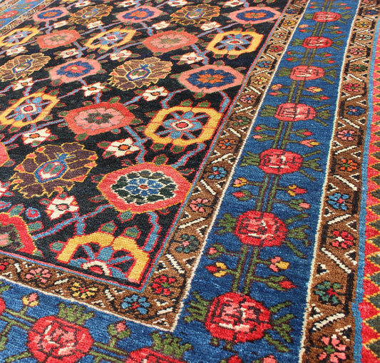 Antique Persian Bakhtiari Rug This antique Persian Bakhtiar rug features an all - over floral pattern in vivid colors of pink, yellow, coral, orange, blue and hints of ivory. The blue border consists of pink and coral flowers with green vines. The... - Keivan Woven ArtsB - 0713 - 2201Rug