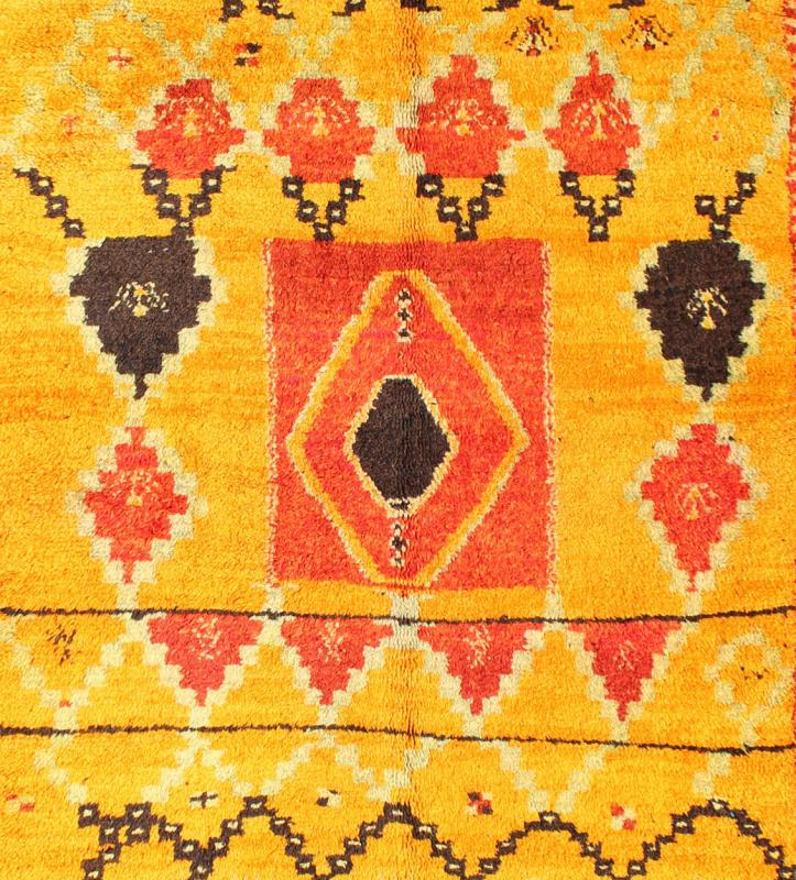 Saffron Colored Antique Moroccan Carpet with Tribal Geometric Design Keivan Woven Arts Measures: 4'4'' x 6'6''. Crafted in the mid - 20th century, this gorgeous Antique Moroccan Rug bears a body of saffron and soft orange and golden hues. Fi... - Keivan Woven ArtsBDS - 136603 - 7267Rug