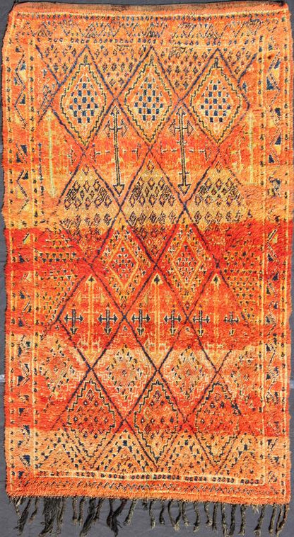 Vintage Moroccan Beni Mklid Rug in Oranges and Creams with Deep Navy Blue Measures: 5'11'' x 10'4''. Woven on a gorgeous luscious black wool base, this original vintage carpet features finely structured diamonds flanked by skillfully woven sy... - Keivan Woven ArtsBDS - 136614 - 7271Rug