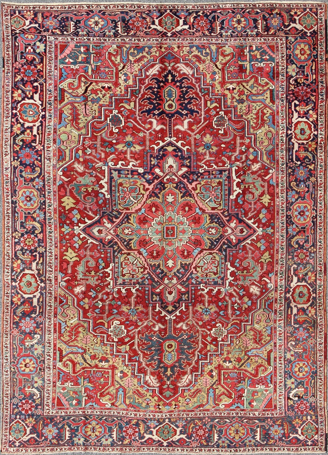 Antique Heriz Carpet with Stylized Floral Motifs and Complementary Border This magnificent antique Persian Heriz carpet from the early 20th century bears an exquisite design rendered in gorgeous, warm hues of red and various shades of blue. A hi... - Keivan Woven ArtsCA - 14882 - 517Rug