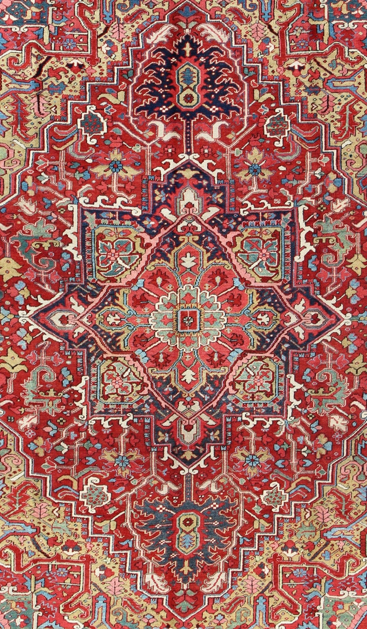 Antique Heriz Carpet with Stylized Floral Motifs and Complementary Border This magnificent antique Persian Heriz carpet from the early 20th century bears an exquisite design rendered in gorgeous, warm hues of red and various shades of blue. A hi... - Keivan Woven ArtsCA - 14882 - 517Rug