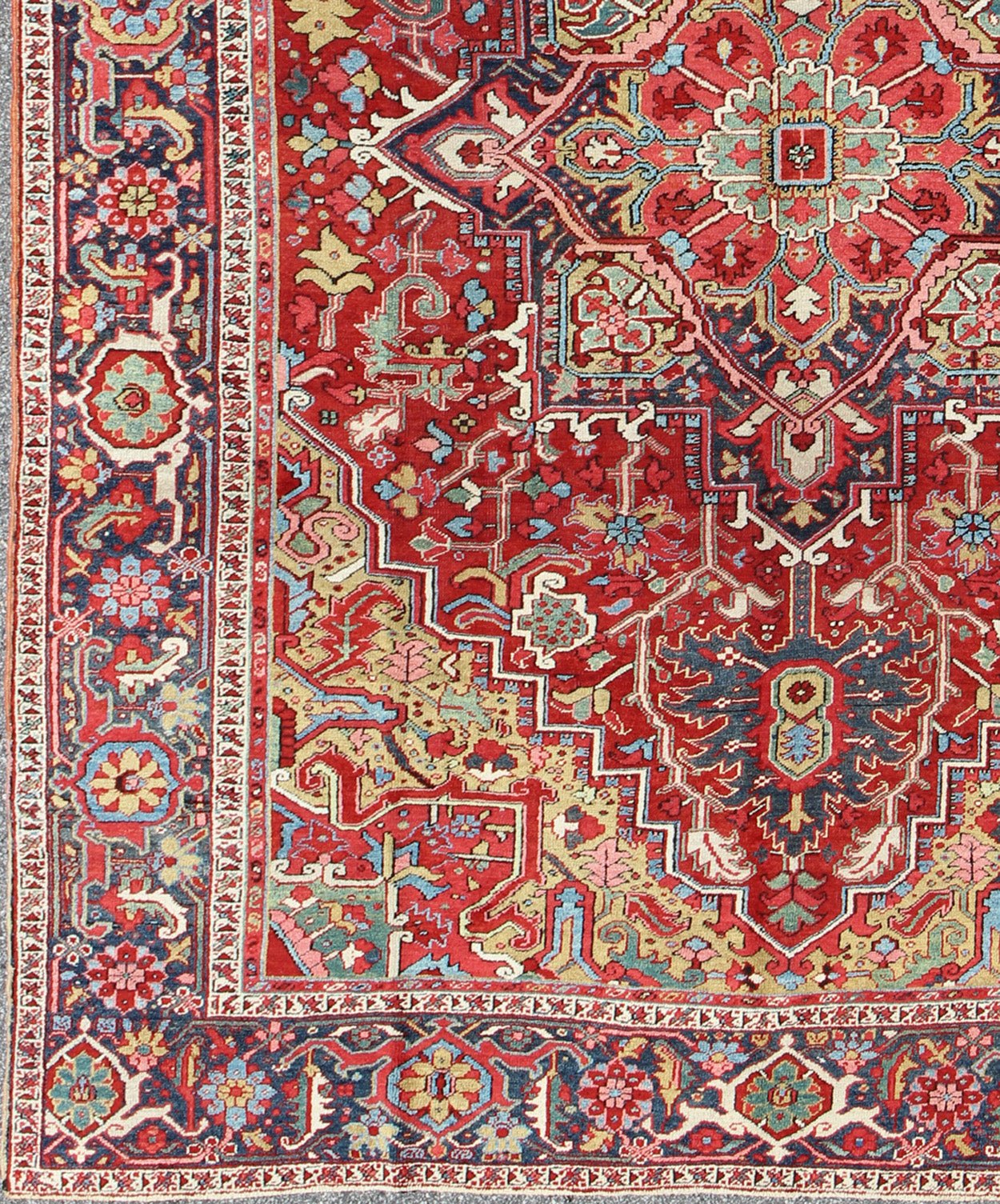 Antique Heriz Carpet with Stylized Floral Motifs and Complementary Border This magnificent antique Persian Heriz carpet from the early 20th century bears an exquisite design rendered in gorgeous, warm hues of red and various shades of blue. A hi... - Keivan Woven ArtsCA - 14882 - 517Rug