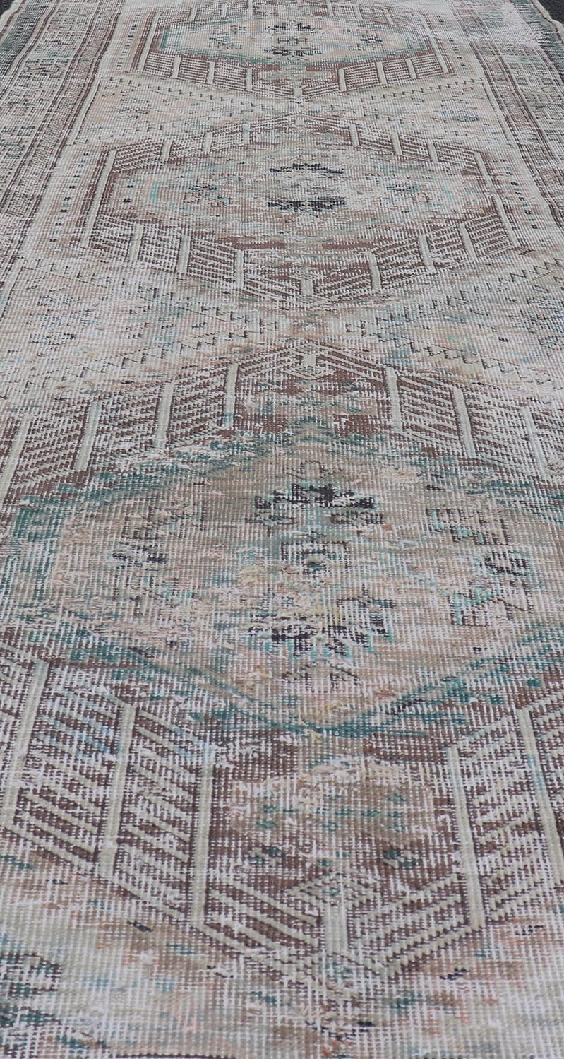 Vintage Persian Heriz Distressed Rug with Muted Colors and Medallion Design. Keivan Woven Arts / rug CRV - 10056889, country of origin / type: Iran / Tabriz, circa 1950 Measures: 3'4 x 10'4 This vintage Persian Tabriz carpet features a ref... - Keivan Woven ArtsCRV - 10056889 - 21415Rug