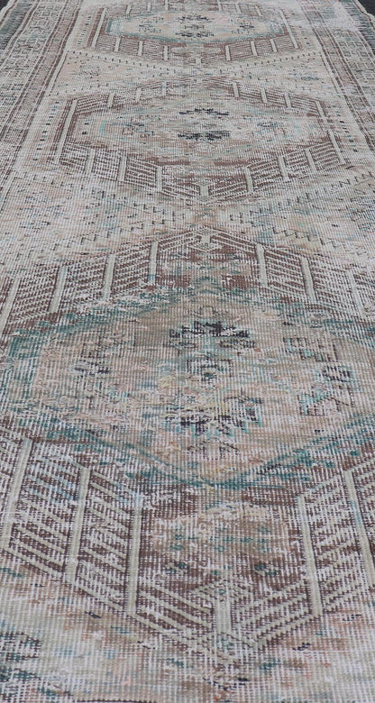 Vintage Persian Heriz Distressed Rug with Muted Colors and Medallion Design. Keivan Woven Arts / rug CRV - 10056889, country of origin / type: Iran / Tabriz, circa 1950 Measures: 3'4 x 10'4 This vintage Persian Tabriz carpet features a ref... - Keivan Woven ArtsCRV - 10056889 - 21415Rug