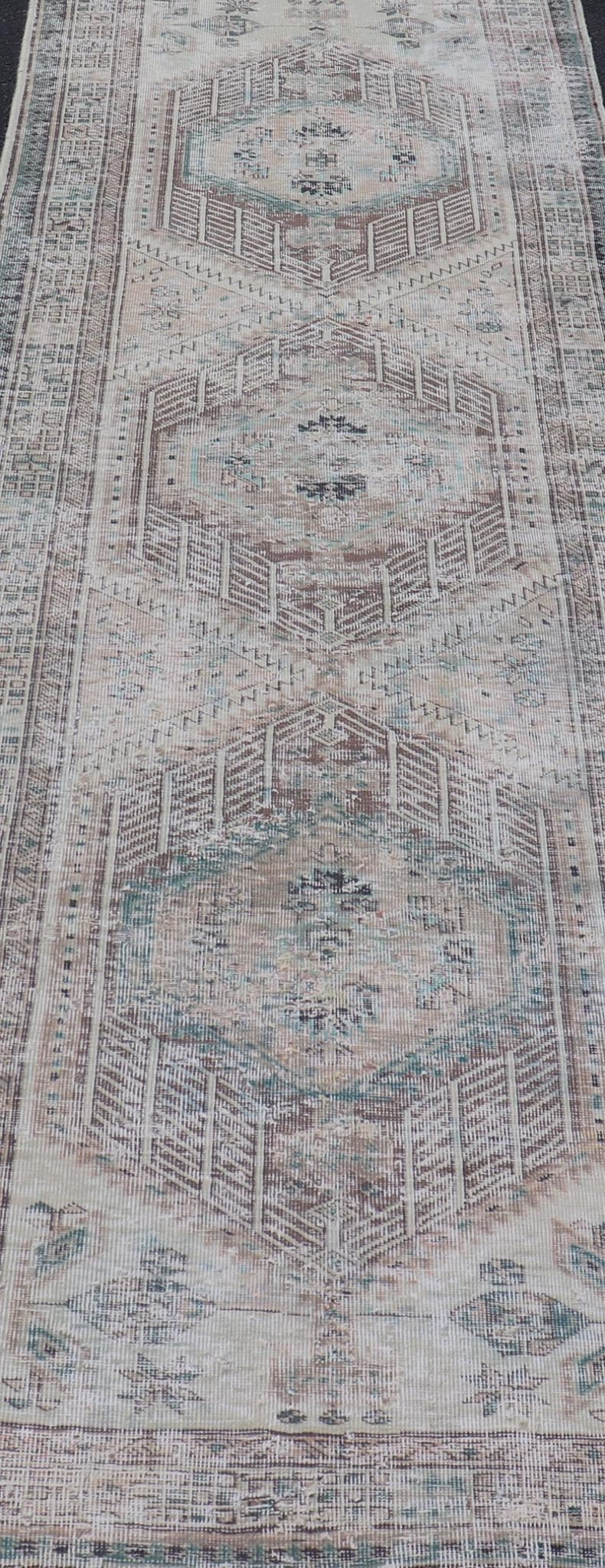 Vintage Persian Heriz Distressed Rug with Muted Colors and Medallion Design. Keivan Woven Arts / rug CRV - 10056889, country of origin / type: Iran / Tabriz, circa 1950 Measures: 3'4 x 10'4 This vintage Persian Tabriz carpet features a ref... - Keivan Woven ArtsCRV - 10056889 - 21415Rug