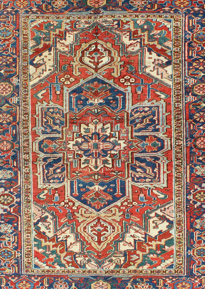 Antique Heriz - Serapi Rug This antique Persian Heriz - Serapi from the early 20th century bears an exquisite design rendered in gorgeous, warm hues of red and denim blue. A highly stylized geometric center medallion anchors the piece and is surroun... - Keivan Woven ArtsD - 0908 - 2205Rug