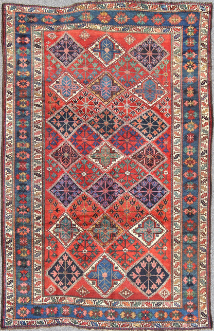 Antique Persian Qashqai Rug with Tulips, Diamond Patterns and Star Motifs This amazing antique Persian Qashqai rug originates from the tribes of southwestern Iran and features a wonderful geometric pattern and traditional color palette. The vari... - Keivan Woven ArtsD - 0909 - 862Rug