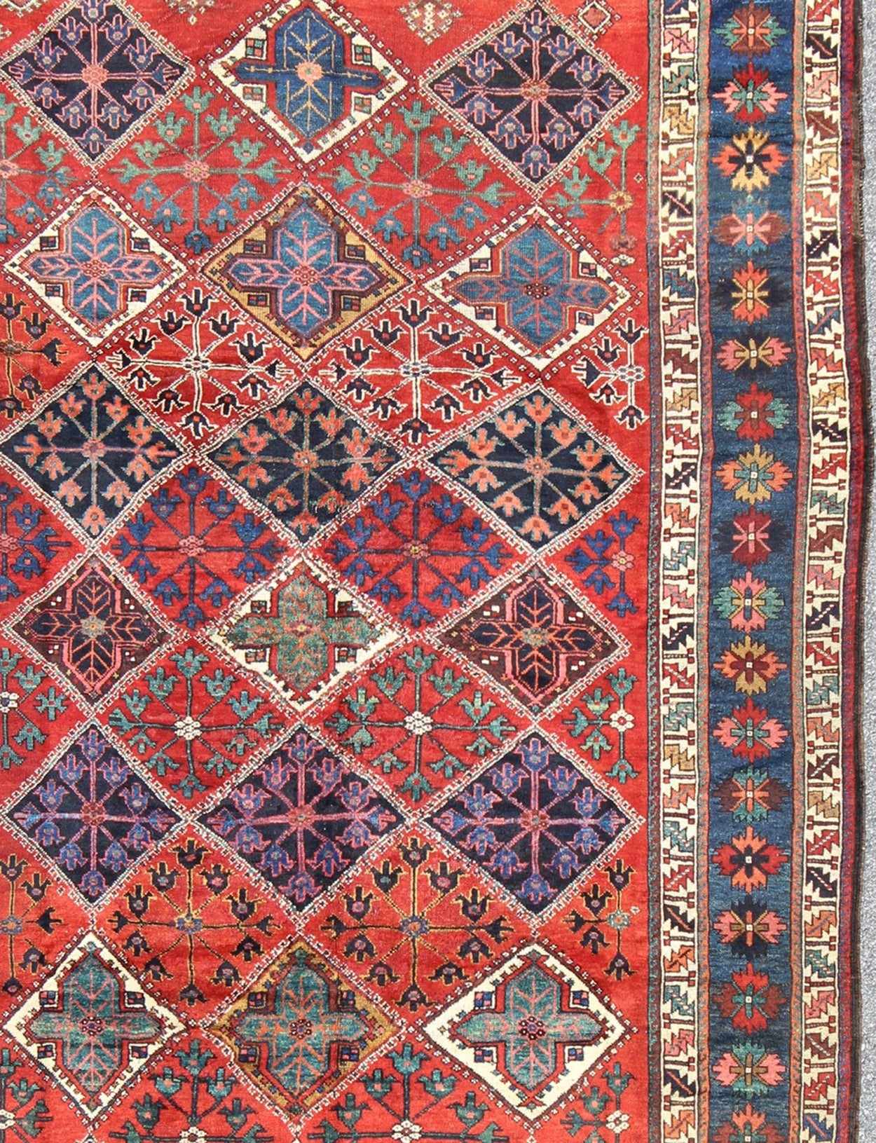 Antique Persian Qashqai Rug with Tulips, Diamond Patterns and Star Motifs This amazing antique Persian Qashqai rug originates from the tribes of southwestern Iran and features a wonderful geometric pattern and traditional color palette. The vari... - Keivan Woven ArtsD - 0909 - 862Rug