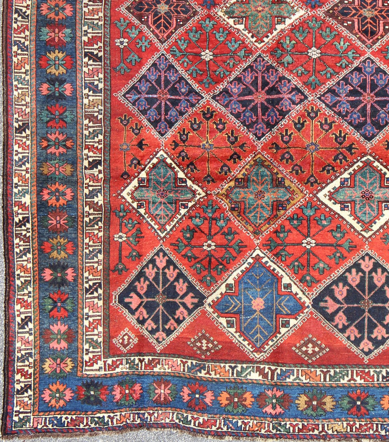 Antique Persian Qashqai Rug with Tulips, Diamond Patterns and Star Motifs This amazing antique Persian Qashqai rug originates from the tribes of southwestern Iran and features a wonderful geometric pattern and traditional color palette. The vari... - Keivan Woven ArtsD - 0909 - 862Rug