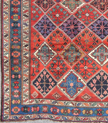 Antique Persian Qashqai Rug with Tulips, Diamond Patterns and Star Motifs This amazing antique Persian Qashqai rug originates from the tribes of southwestern Iran and features a wonderful geometric pattern and traditional color palette. The vari... - Keivan Woven ArtsD - 0909 - 862Rug