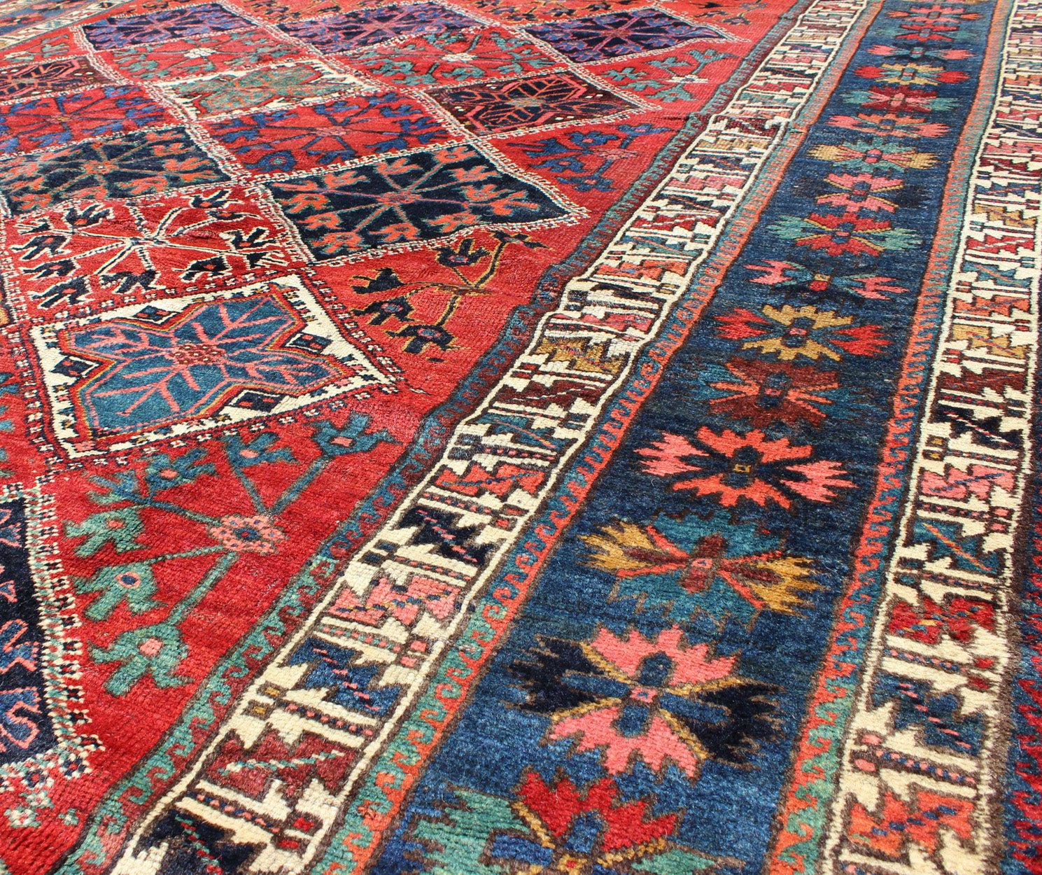 Antique Persian Qashqai Rug with Tulips, Diamond Patterns and Star Motifs This amazing antique Persian Qashqai rug originates from the tribes of southwestern Iran and features a wonderful geometric pattern and traditional color palette. The vari... - Keivan Woven ArtsD - 0909 - 862Rug
