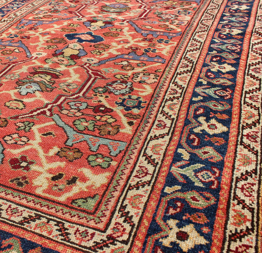 Antique Persian Sultanabad Rug A beautiful Sultanabad rug, this piece features a cinnamon - shaded field bearing an intricate floral motif of repeating red, light purple and pink flowers. A thin blue border displays straight rows of single blossom... - Keivan Woven ArtsD - 0924 - 1847