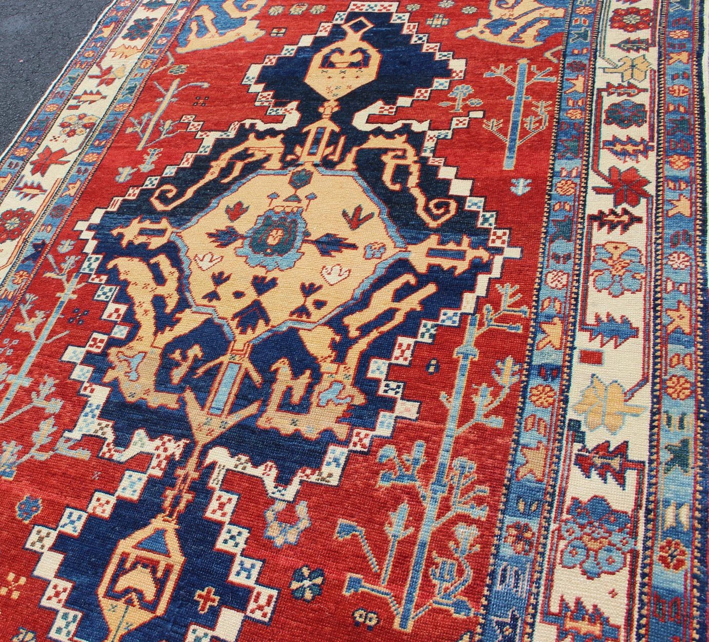 Vintage Turkish Tribal Rug with Jewel - Toned Central Medallion and Vivid Border This vintage Turkish Tribal rug features a large central medallion and a jewel - toned geometric design surrounded by a vivid blue and ivory border. Measures: 4'9 x ... - Keivan Woven ArtsDSP - WL30362 - 4134Rug