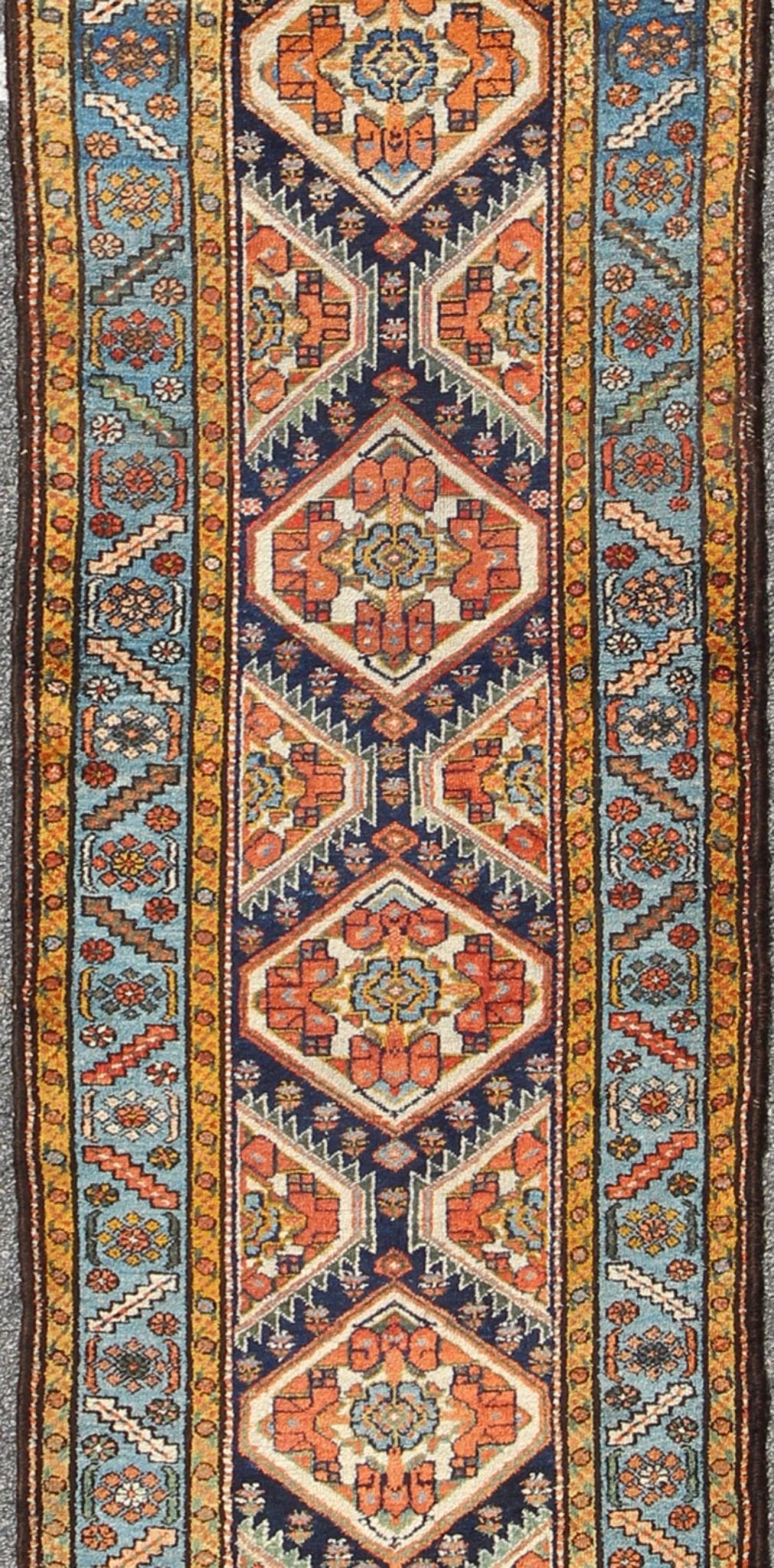 Colorful 1920s Antique N.W. Persian Runner with Sub - Geometric Medallions, rug e - 0603, country of origin / type: Iran / N.W. Persian, circa 1920 This Northwest Persian runner features a deep blue background flanked by multiple light blue and yell... - Keivan Woven ArtsE - 0603 - 1446Rug