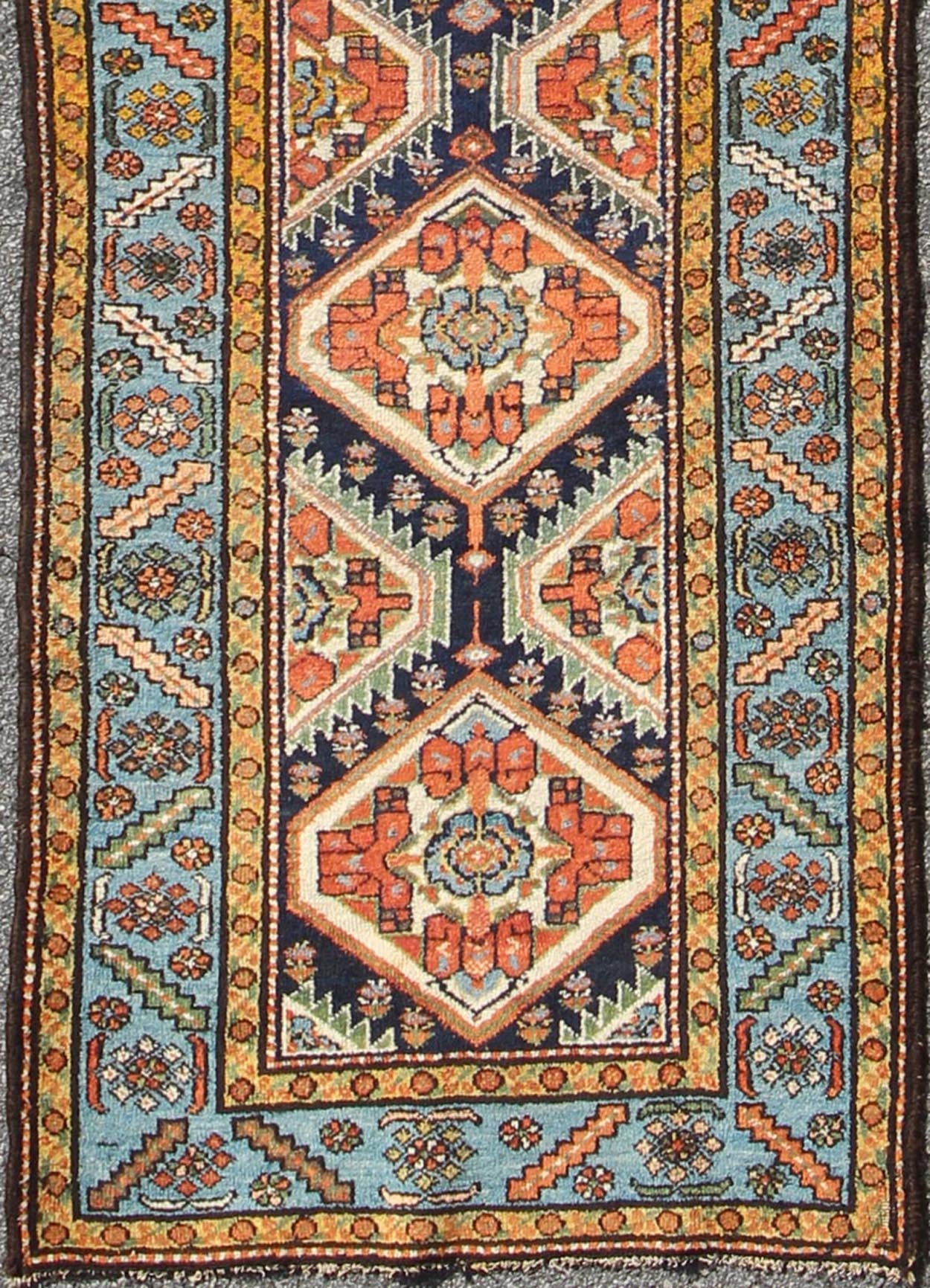 Colorful 1920s Antique N.W. Persian Runner with Sub - Geometric Medallions, rug e - 0603, country of origin / type: Iran / N.W. Persian, circa 1920 This Northwest Persian runner features a deep blue background flanked by multiple light blue and yell... - Keivan Woven ArtsE - 0603 - 1446Rug