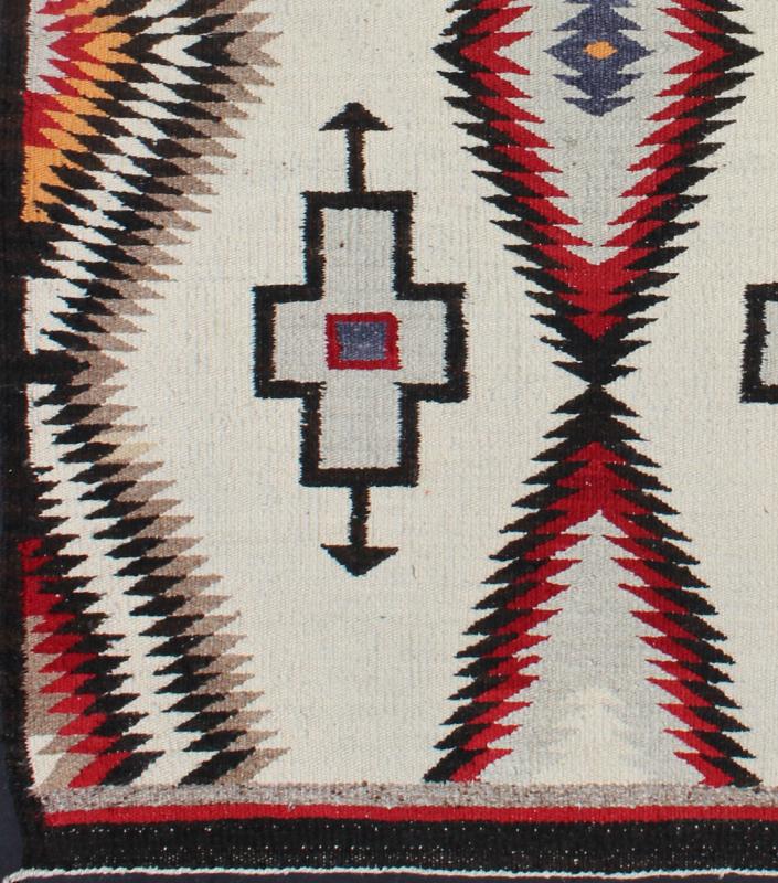 Antique Navajo Rug in Gray, Ivory, Black, Orange, and Red This Southwestern Navajo rug features designs and coloring most consistent with textiles that originated at the Ganado Trading Post. It's woven of native, hand - spun wool in natural color... - Keivan Woven ArtsEBD - 1007 - 6470Rug