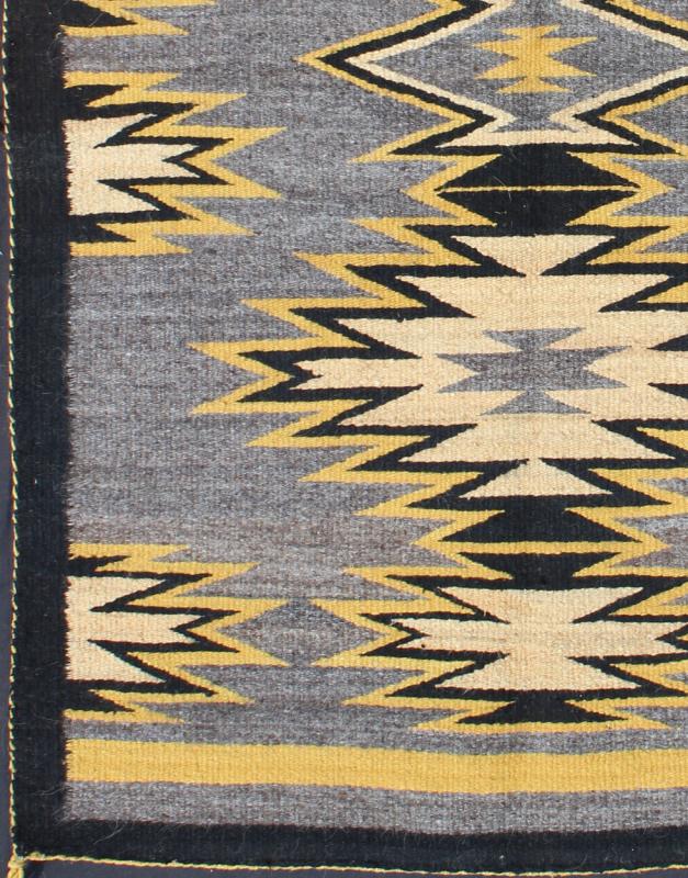 Geometric Medallion Tribal Navajo Kilim with Cream, Gold, Gray and Black This intriguing antique Navajo Kilim, circa 1940 was woven in the United States during the first half of the 20th century. The exciting and unique composition boasts a capt... - Keivan Woven ArtsEBD - 1025 - 6564Rug