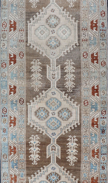 Long Persian Heriz Runner with Central Medallions in Brown, Blue, Tan & Red. Antique Heriz Persian long runner with multi - medallion and geometric design from Persia, rug EMA - 7568 , country of origin / type: Iran / Heriz, circa 1920 This m... - Keivan Woven ArtsEMA - 7568 - 9838Rug