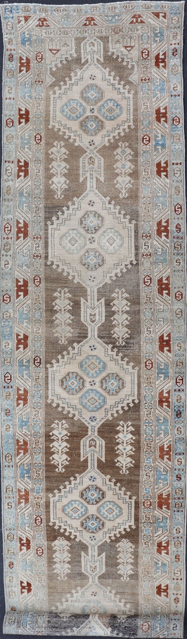 Long Persian Heriz Runner with Central Medallions in Brown, Blue, Tan & Red. Antique Heriz Persian long runner with multi - medallion and geometric design from Persia, rug EMA - 7568 , country of origin / type: Iran / Heriz, circa 1920 This m... - Keivan Woven ArtsEMA - 7568 - 9838
