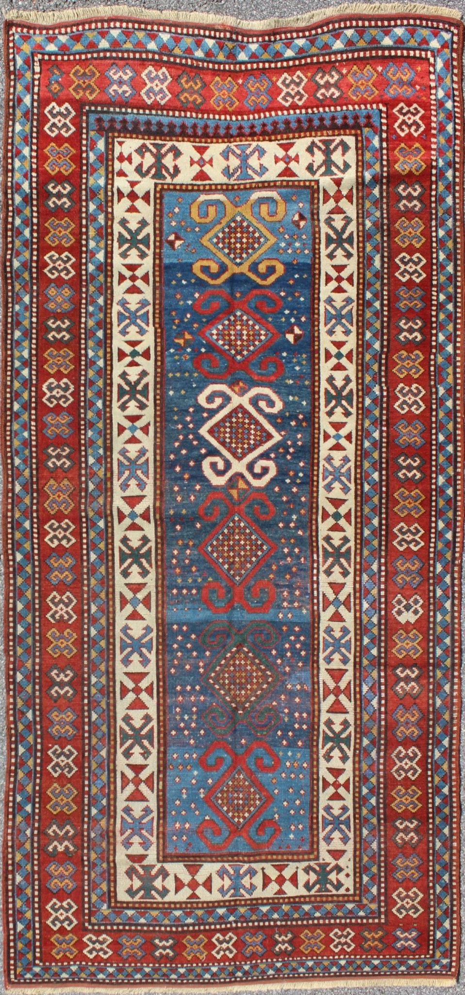 Red and Blue Antique Caucasian Kazak Rug with Vertical Tribal Medallions. Keivan Woven Arts / rug EMAC - 001, country of origin / type: Caucasus / Kazak, circa 1890 Measures: 4' x 8'10 The field design of this late 19th century antique Caucasian K... - Keivan Woven ArtsEMAC - 001 - 8801Rug