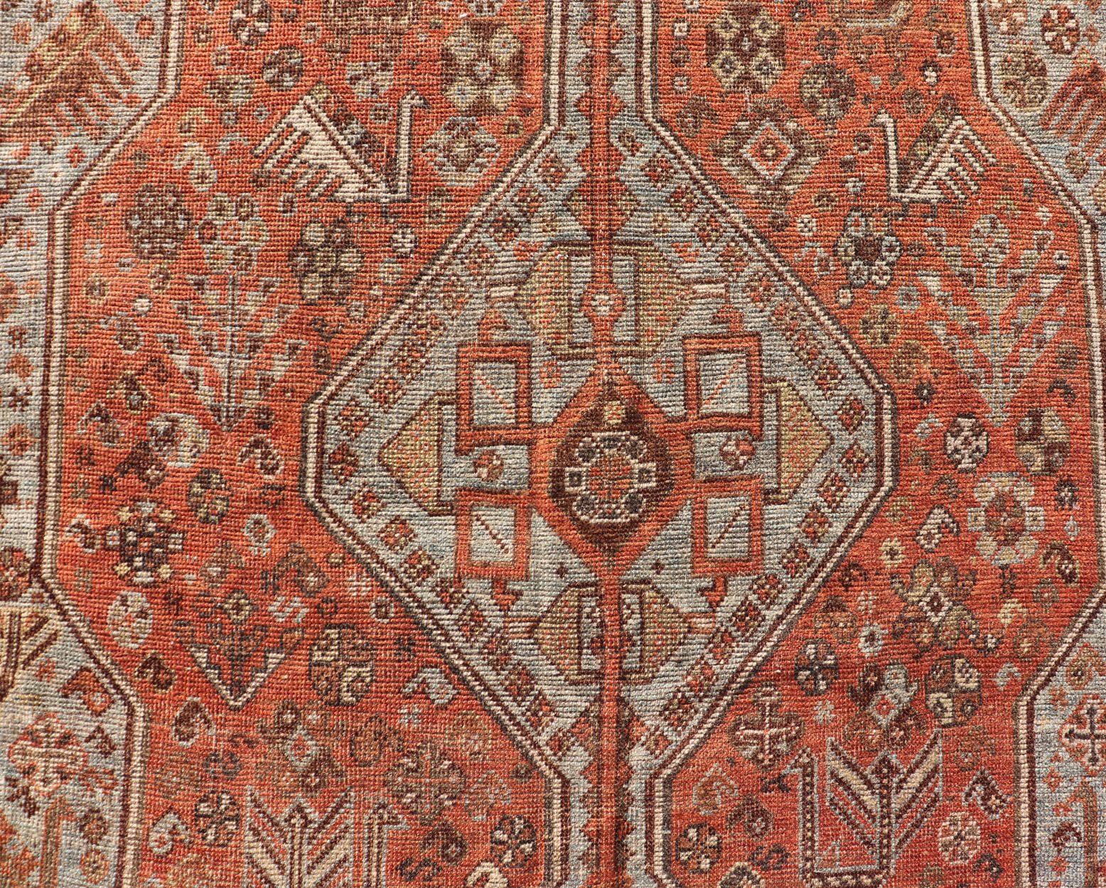 Measures: 7'0 x 10'1 Antique Persian Shiraz Rug With Medallions Geometric in Rusty Orange, Steel Blue. Keivan Woven Arts / rug EMB - 22108 - 15052, country of origin / type: Iran / Shiraz, circa 1920. This antique distressed Persian Shiraz rug (cir... - Keivan Woven ArtsEMB - 22108 - 15052 - 20547Rug