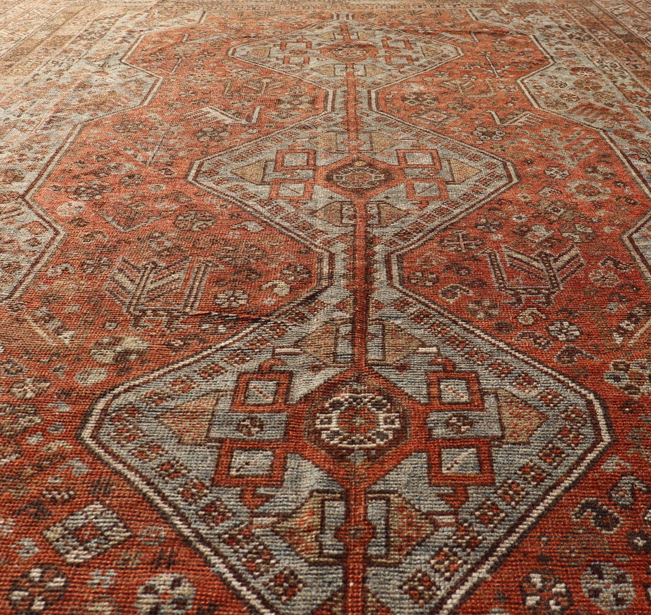 Measures: 7'0 x 10'1 Antique Persian Shiraz Rug With Medallions Geometric in Rusty Orange, Steel Blue. Keivan Woven Arts / rug EMB - 22108 - 15052, country of origin / type: Iran / Shiraz, circa 1920. This antique distressed Persian Shiraz rug (cir... - Keivan Woven ArtsEMB - 22108 - 15052 - 20547Rug