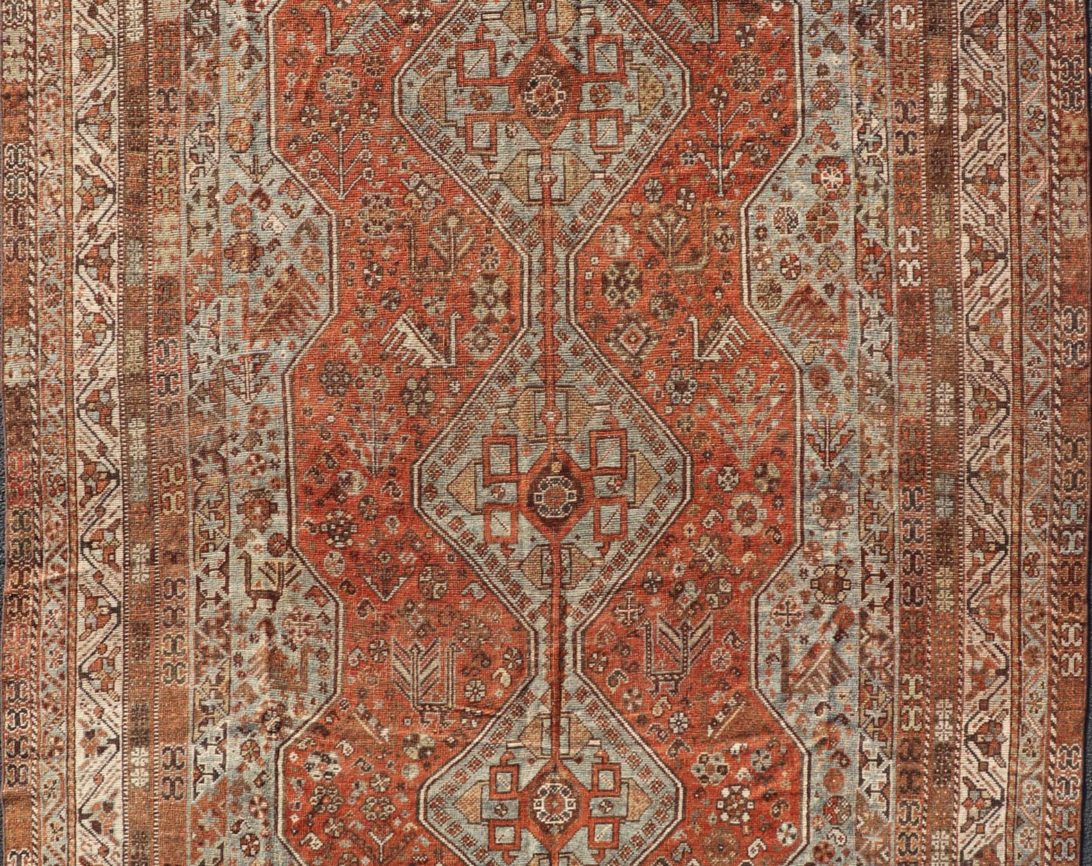 Measures: 7'0 x 10'1 Antique Persian Shiraz Rug With Medallions Geometric in Rusty Orange, Steel Blue. Keivan Woven Arts / rug EMB - 22108 - 15052, country of origin / type: Iran / Shiraz, circa 1920. This antique distressed Persian Shiraz rug (cir... - Keivan Woven ArtsEMB - 22108 - 15052 - 20547Rug