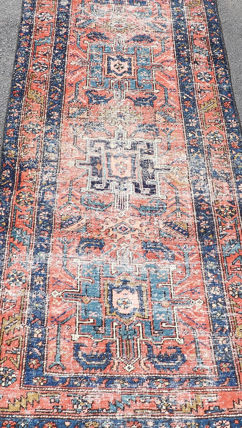 Geometric Medallion Antique Persian Heriz Runner in Orange - Red and Blue. Keivan Woven Arts / rug EMB - 22117 - 15011, country of origin / type: Iran / Heriz, circa 1920 Measures: 3'0 x 10'7 This antique Persian Heriz runner, from northwest Iran, dis... - Keivan Woven ArtsEMB - 22117 - 15011 - 20319Rug