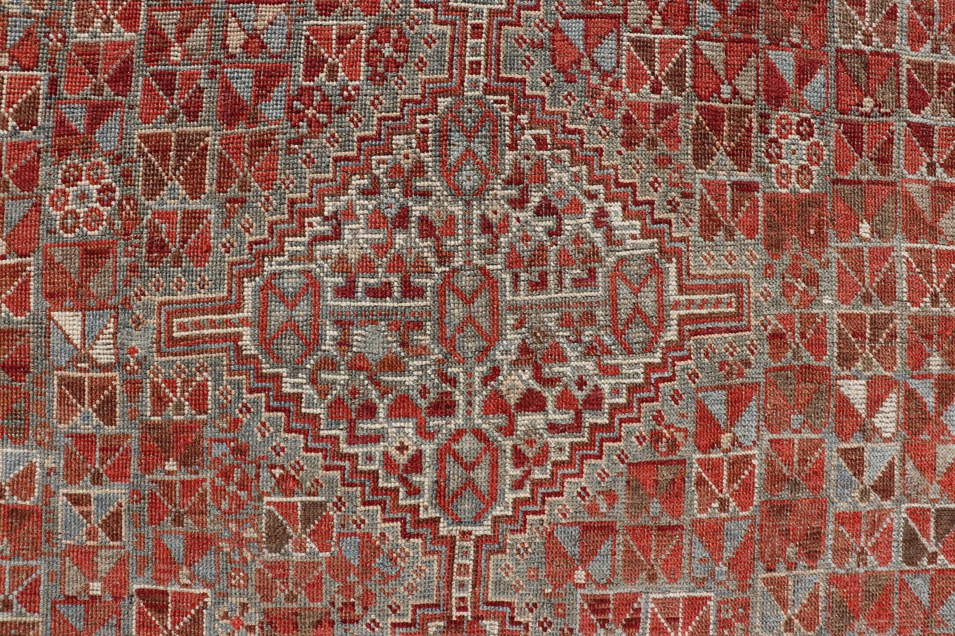 Antique Distressed Persian Medallion Shiraz Rug in Shades Rusty Red & Steel Blue. Keivan Woven Arts / rug EMB - 22190 - 15055, country of origin / type: Iran / Shiraz, circa 1910. Measures: 5'0 x 6'10 This antique distressed Persian Shiraz rug (circ... - Keivan Woven ArtsEMB - 22190 - 15055 - 20565