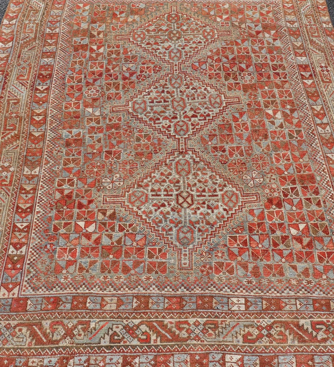 Antique Distressed Persian Medallion Shiraz Rug in Shades Rusty Red & Steel Blue. Keivan Woven Arts / rug EMB - 22190 - 15055, country of origin / type: Iran / Shiraz, circa 1910. Measures: 5'0 x 6'10 This antique distressed Persian Shiraz rug (circ... - Keivan Woven ArtsEMB - 22190 - 15055 - 20565
