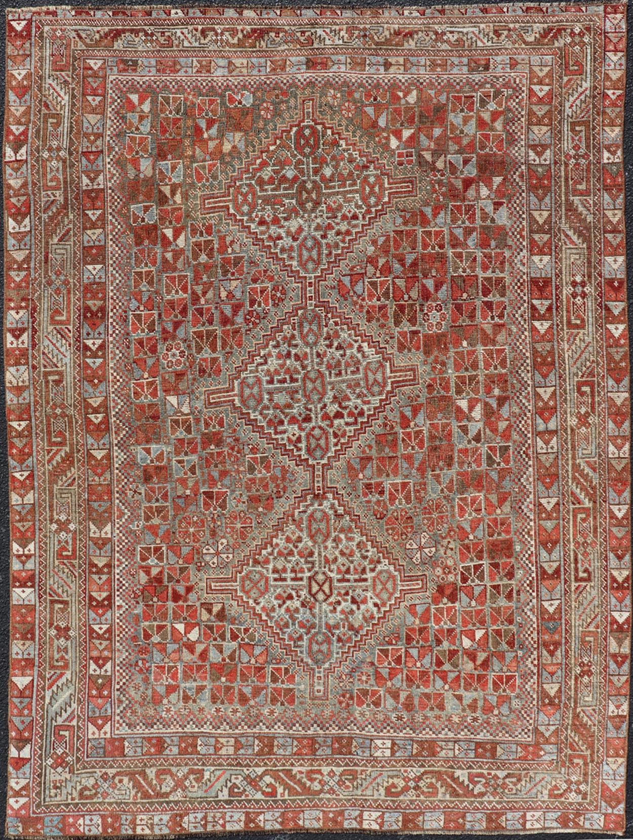 Antique Distressed Persian Medallion Shiraz Rug in Shades Rusty Red & Steel Blue. Keivan Woven Arts / rug EMB - 22190 - 15055, country of origin / type: Iran / Shiraz, circa 1910. Measures: 5'0 x 6'10 This antique distressed Persian Shiraz rug (circ... - Keivan Woven ArtsEMB - 22190 - 15055 - 20565