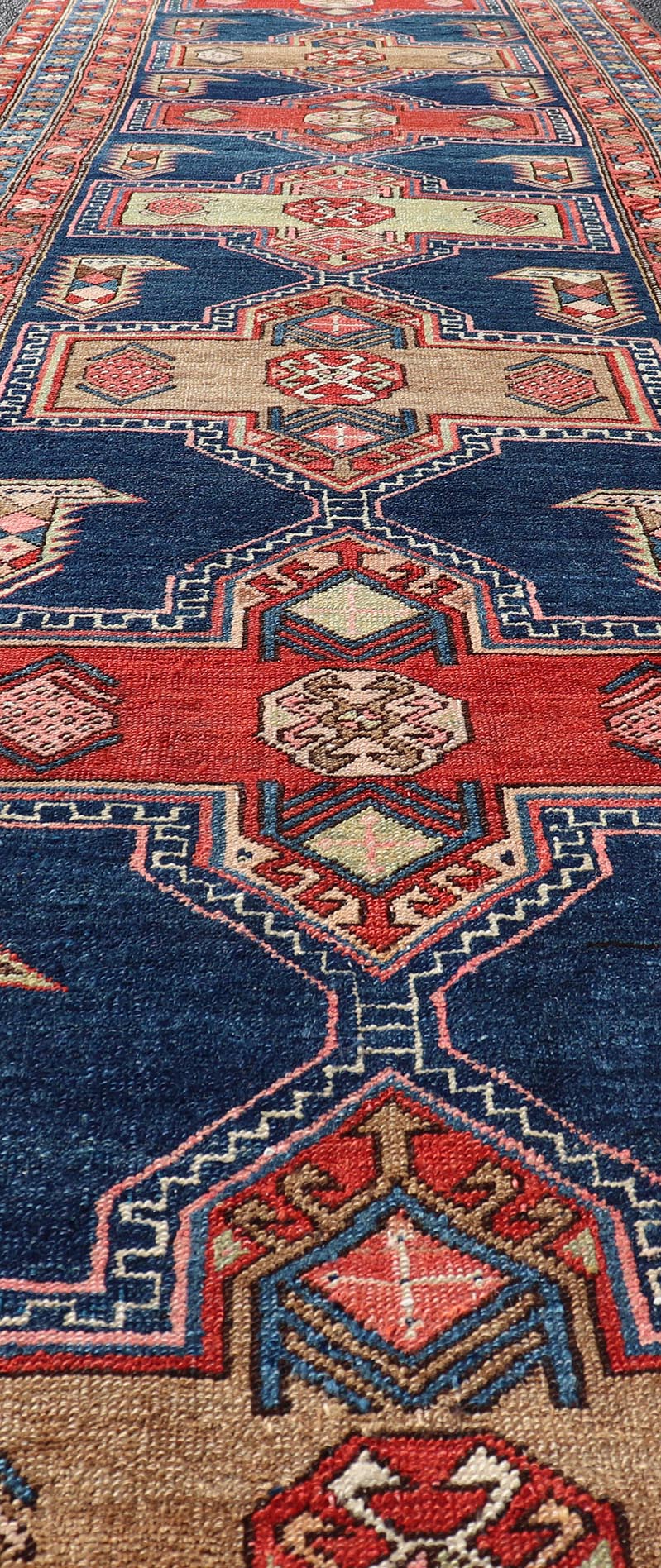 Measures: 3'5 x 13'4 Bold Medallion Design Antique Persian Heriz Runner in Red and Blue Tones. Keivan Woven Arts / rug EMB - 22195 - 15097, country of origin / type: Iran / Heriz, circa 1910 This antique Persian Heriz runner, from northwest Iran... - Keivan Woven ArtsEMB - 22195 - 15097 - 20758