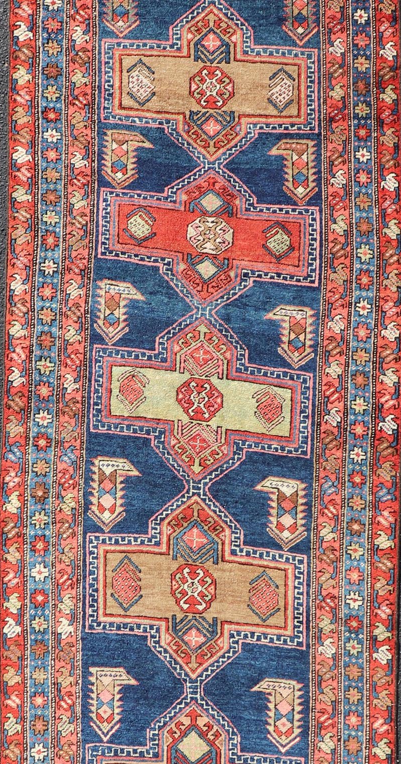 Measures: 3'5 x 13'4 Bold Medallion Design Antique Persian Heriz Runner in Red and Blue Tones. Keivan Woven Arts / rug EMB - 22195 - 15097, country of origin / type: Iran / Heriz, circa 1910 This antique Persian Heriz runner, from northwest Iran... - Keivan Woven ArtsEMB - 22195 - 15097 - 20758