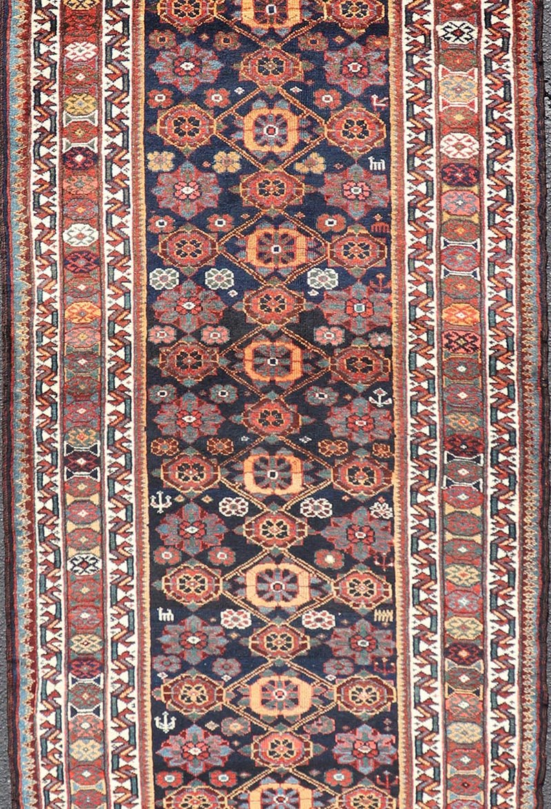 Colorful Antique Persian Lori Runner with Repeating Floral Palmette Design. Keivan Woven Arts / rug EMB - 22229 - 15464, country of origin / type: Iran / Lori, circa 1920 Measures: 3'6 x 11 This antique Persian Lori runner, circa early 20th cent... - Keivan Woven ArtsEMB - 22229 - 15464 - 21585Rug