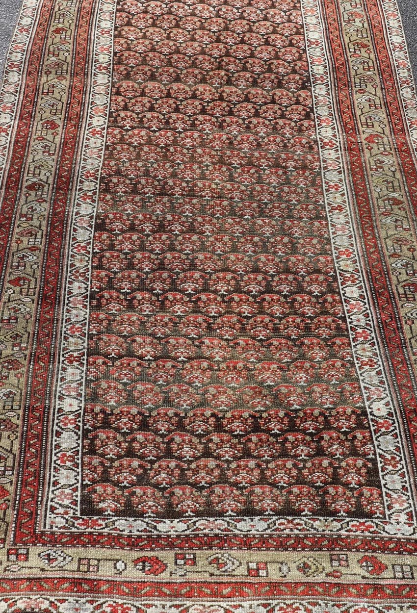 Antique Kurdish Gallery Runner with All - Over Paisley Design in Brown, Red, Green. Keivan Woven Arts / rug EMB - 22230 - 15466, country of origin / type: Iran / Kurdish, circa 1920. Measures: 4'3 x 10'1 This Kurdish gallery runner from early 20th cen... - Keivan Woven ArtsEMB - 22230 - 15466 - 21591
