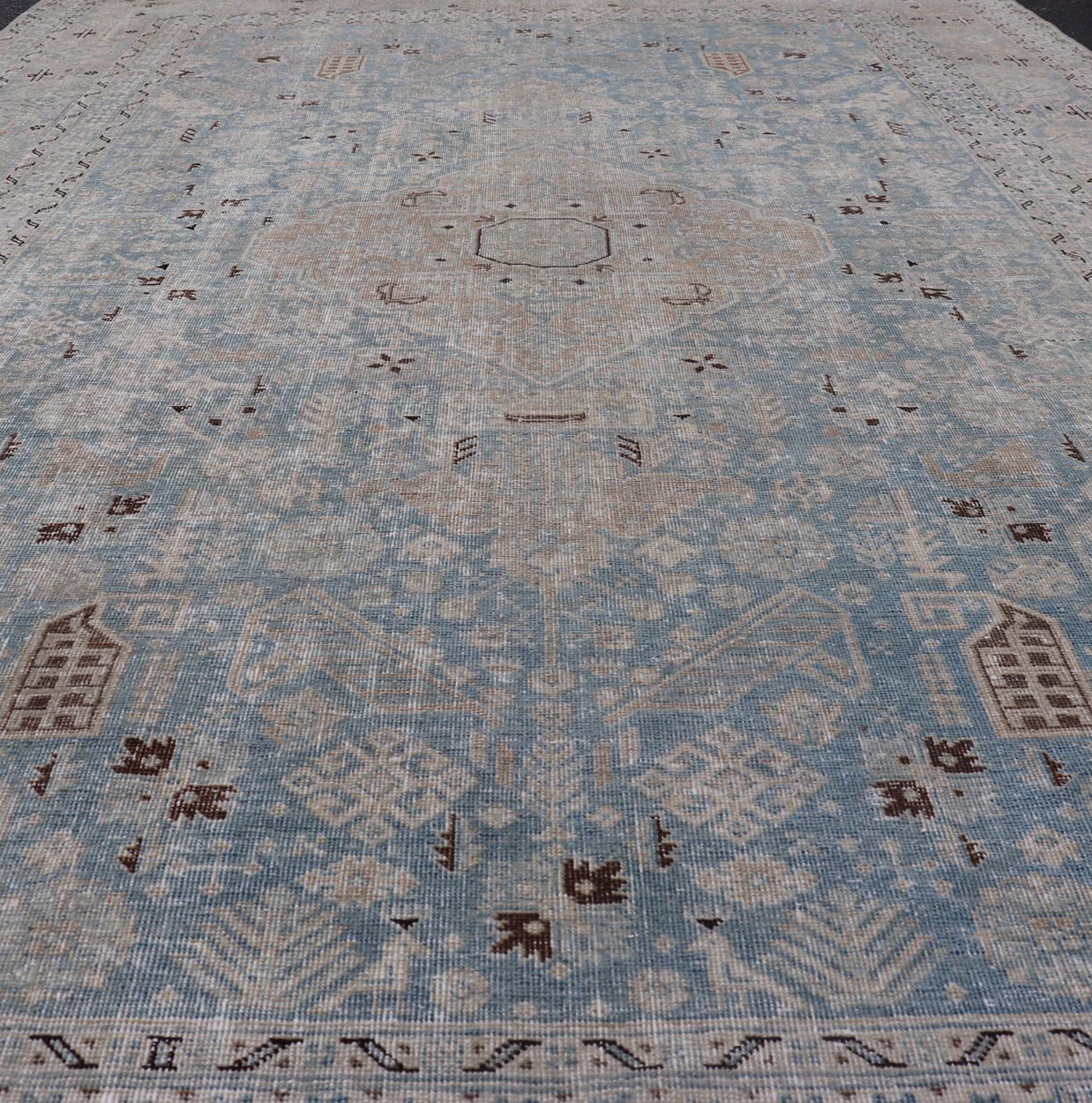 Measures: 6'0 x 9'0 The rug's central field is highlighted by a soft blue background adorned with a detailed medallion pattern in shades of beige and ivory. The design includes various geometric and floral motifs that are arranged symmetrically, cr... - Keivan Woven ArtsEMB - 22236 - 22460